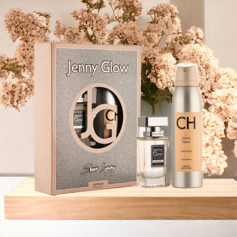Jenny Glow product set with packaging and bottles on a wooden surface with flowers in the background