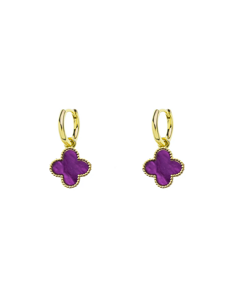 Gold earrings with purple clover-shaped charms on a white background